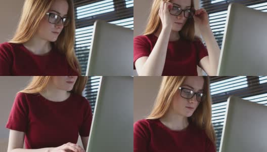 上网学习笔记本电脑，年轻女子戴眼镜。多莉。高清在线视频素材下载