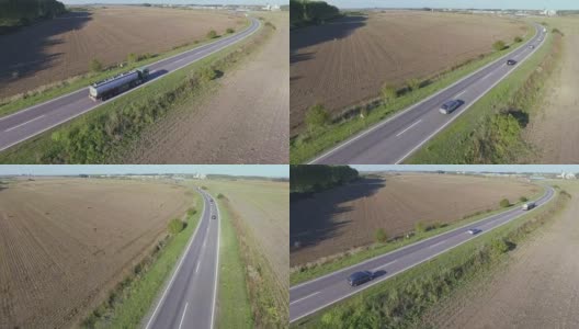 从空中拍摄在乡村道路上行驶的车辆高清在线视频素材下载