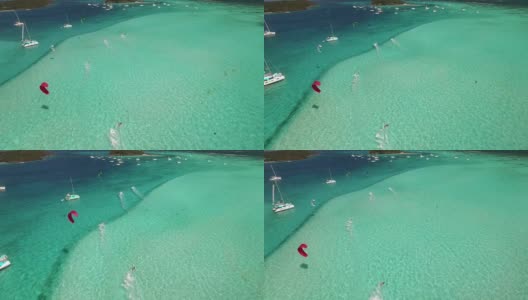 航拍的风筝冲浪者在加勒比海平坦的水面上高清在线视频素材下载