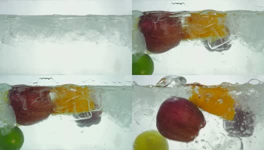 青柠、橙、苹果和柠檬滴在冰水里。关闭了。缓慢的运动。高清在线视频素材下载
