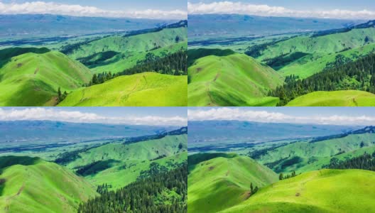 空中拍摄的新疆那拉提草原上的绿草和山。高清在线视频素材下载