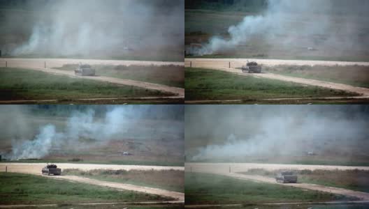 俄罗斯军队坦克战争机器在尘土飞扬的道路上行驶，射击演习。高清在线视频素材下载