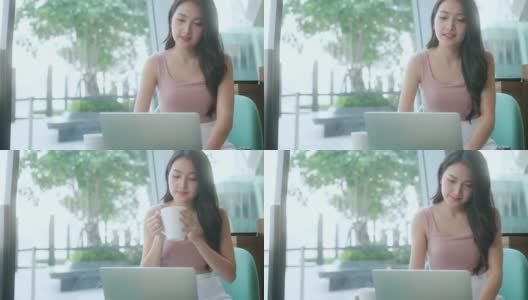 女性的手年轻的亚洲女性用户工人使用笔记本电脑打字笔记本电脑键盘坐在咖啡馆的桌子上工作与笔记本电脑软件应用技术的概念高清在线视频素材下载