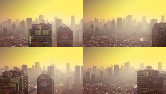 雅加达,印度尼西亚。2017年12月26日:黄昏时分，无人机从左到右飞行，鸟瞰雾霭中的摩天大楼和橙色天空，分辨率为4k高清在线视频素材下载