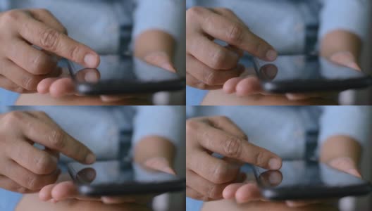 近距离观察一名女子的手指，她正在移动应用程序上滚动智能手机触摸屏上的在线购物项目。高清在线视频素材下载