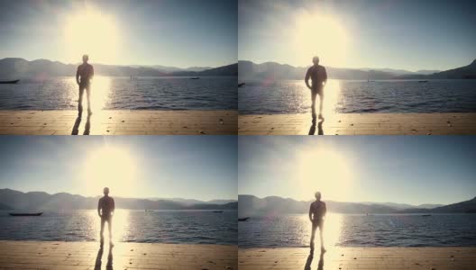 日落时分，一个人站在湖边高清在线视频素材下载