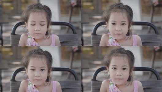 近距离的美丽和可爱的脸与闪烁的眼睛5岁的亚洲女孩谁是看着相机的自信和幸福表达积极的态度和坚定的情绪。高清在线视频素材下载