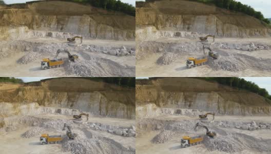 露天开采建筑砂石材料用挖掘机和自卸卡车。高清在线视频素材下载