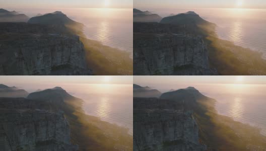 桌山国家公园浪漫的全景照片。低太阳下海岸岩石山脉的航拍镜头。南非开普敦高清在线视频素材下载