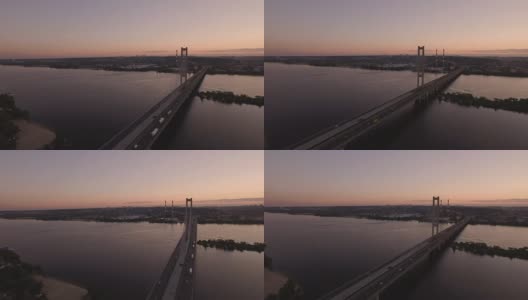 日落时分，无人机拍摄到河上的大桥高清在线视频素材下载