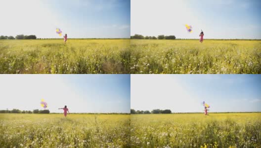 女人拿着彩色气球在草地上奔跑高清在线视频素材下载