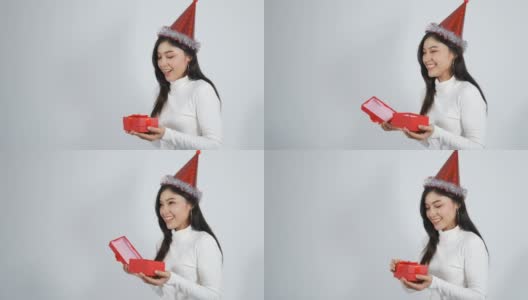 女人打开白色背景的圣诞礼品盒高清在线视频素材下载