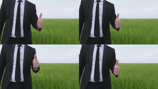 一个穿黑色西装的男人竖起大拇指，表示高兴高清在线视频素材下载