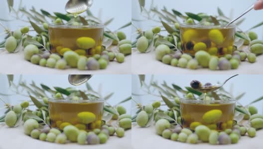 丰富的季节性收获橄榄水果，勺子成熟橄榄水果和滴橄榄油在慢动作，有机橄榄油生产高清在线视频素材下载