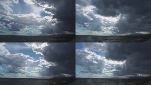 海景在下雨。阳光穿透了暴风雨的云层。雨滴落在相机镜头上。雷云覆盖天空，开始下雨，这是暴风雨前的自然现象。全高清延时高清在线视频素材下载