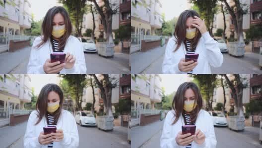 戴着防护口罩的年轻女子使用智能手机的特写镜头高清在线视频素材下载