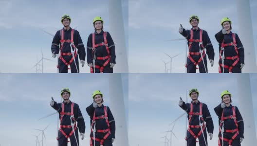 两名身穿安全装备的维修工程师站在高处，竖起大拇指，骄傲地微笑着为他们的服务，清洁能源理念，可再生能源，拯救世界。高清在线视频素材下载