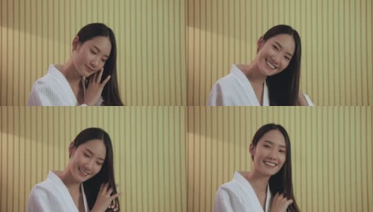 漂亮的亚洲人笑了，她很高兴去美容院让它更漂亮。高清在线视频素材下载