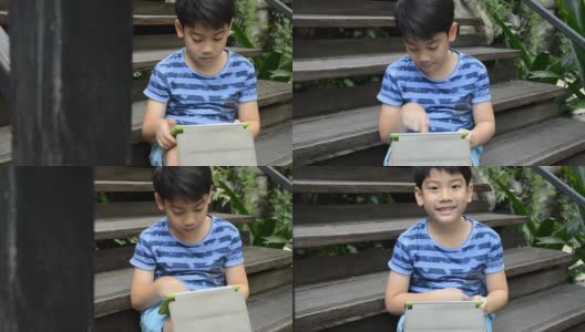 Young Asian child using a digital tablet高清在线视频素材下载