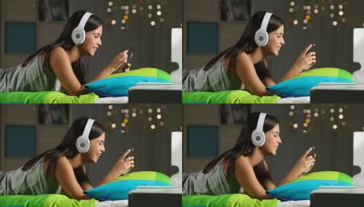 青少年在家里的床上用智能手机看在线视频高清在线视频素材下载
