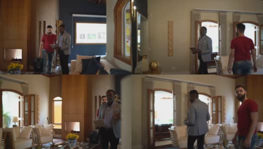 房地产经纪人边走边向客人展示平板电脑高清在线视频素材下载