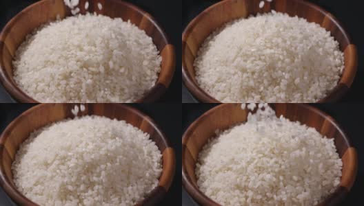 缓慢下落的日本大米。木碗里的生米粒高清在线视频素材下载