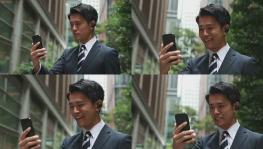 快乐的亚洲商人使用无线耳机进行电话会议高清在线视频素材下载