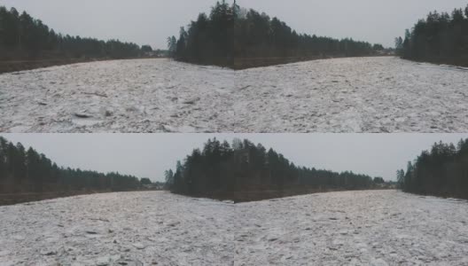 巨大的冰块漂流在拉脱维亚的食人河。空中龙拍摄雪城日。春天这条河上的交通堵塞。一大群移动的冰块高清在线视频素材下载