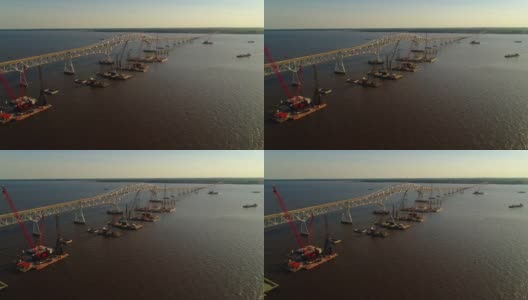 波托马克河重建鸟瞰图，靠近哈里·尼斯州长纪念馆/参议员托马斯·“麦克”·米德尔顿桥，连接弗吉尼亚州和马里兰州，水上有多艘浮吊船和建筑工地。高清在线视频素材下载