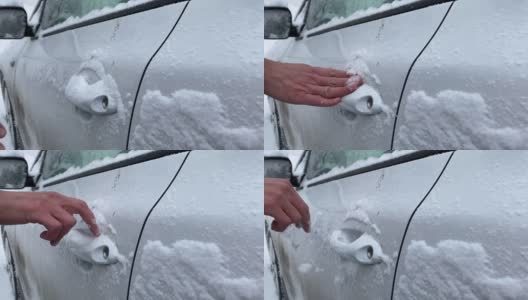 在冬天的早晨，一名无法辨认的男性司机用手清理车门把手上的新雪。高清在线视频素材下载