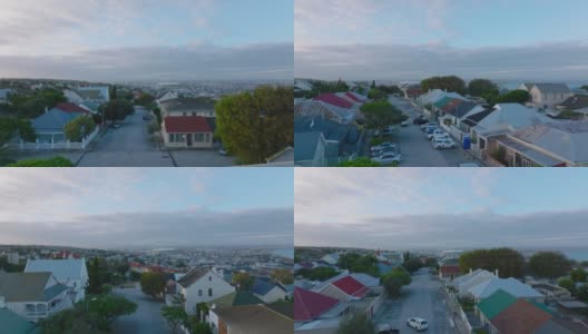 城市沿街的彩色屋顶住宅。向前飞在城市街区上方，展现城镇的全景。南非伊丽莎白港高清在线视频素材下载