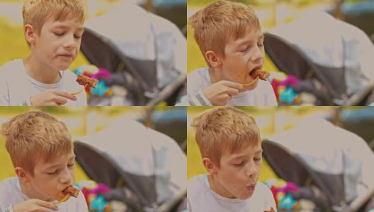 男孩吃烤肉串高清在线视频素材下载