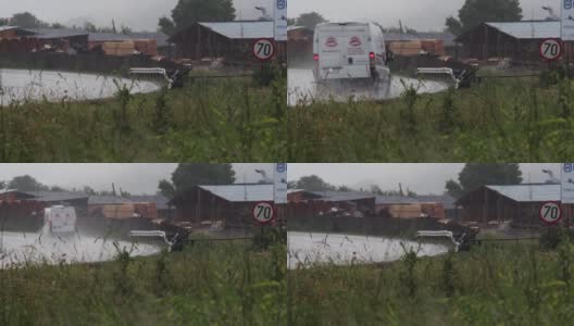 一辆货车在潮湿的道路上行驶，因为夏季的大雨高清在线视频素材下载