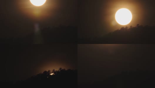 使用超远摄镜头拍摄日落时分大太阳下的4k快速特写场景，在一天结束的时候，山岭上树木的剪影高清在线视频素材下载