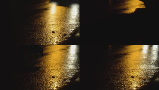 午夜时分，汽车的前灯映照在潮湿的柏油路上高清在线视频素材下载