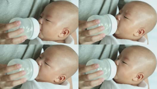 妈妈抱着宝宝喝牛奶高清在线视频素材下载