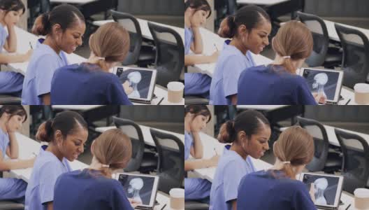 女医学生在数码平板电脑上检查x射线图像高清在线视频素材下载