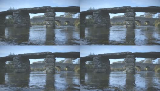 美丽的低空拍摄的古老的拍板桥在达特穆尔，英格兰高清在线视频素材下载
