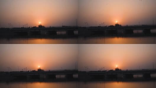 纳尔默达运河大桥在日落在甘地那格-艾哈迈达巴德路，艾哈迈达巴德，古吉拉特邦，印度。过桥车辆。高清在线视频素材下载