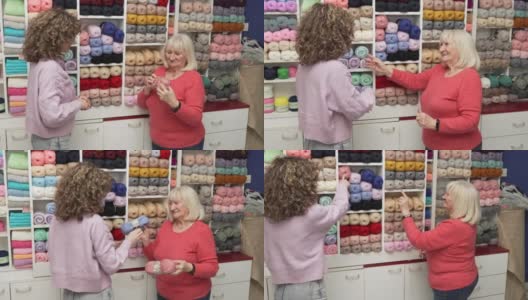 有爱心的年轻女售货员帮助女高级顾客选择羊毛的颜色高清在线视频素材下载