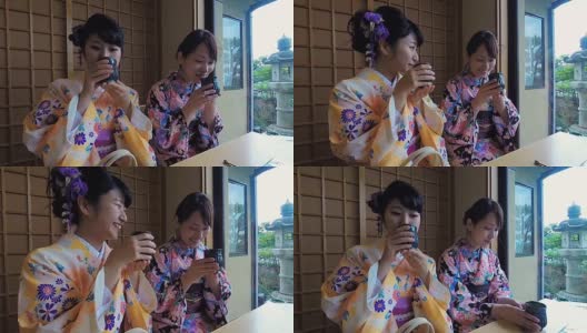 年轻的日本女性穿着传统和服喝茶高清在线视频素材下载
