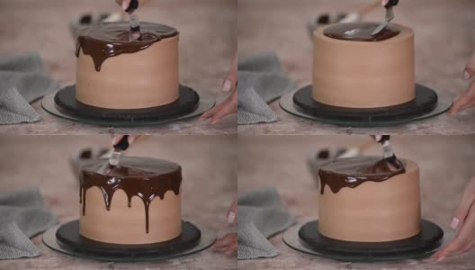 糕点师正用刀在蛋糕上涂上巧克力釉来装饰蛋糕。巧克力从两边流下来。高清在线视频素材下载