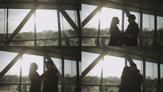 机场夕阳下一对恋人的剪影。高清在线视频素材下载