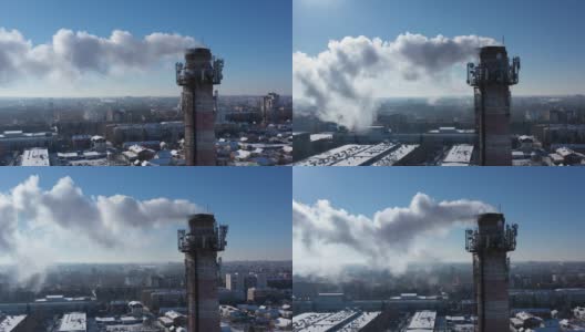 带着白烟的烟斗。城市燃气锅炉房的管道，白色的烟雾映衬着天空。俯视图从无人机。高清在线视频素材下载
