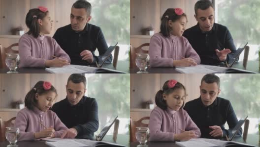 父亲帮助女儿做家庭作业高清在线视频素材下载