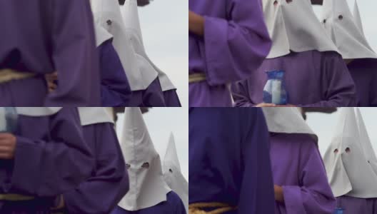 复活节期间，身穿白色头巾和紫色长袍的男子手持蜡烛高清在线视频素材下载
