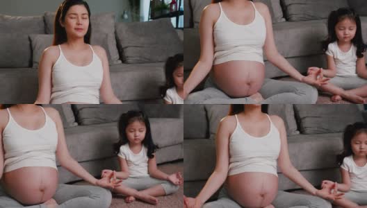 怀孕期间和她可爱的女儿在一起，练习正念可以提升积极的感觉，或者冥想可以减少压力。高清在线视频素材下载