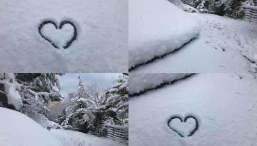 在雪天的冬天，在雪天的街道上，在停放的汽车上手绘心形高清在线视频素材下载