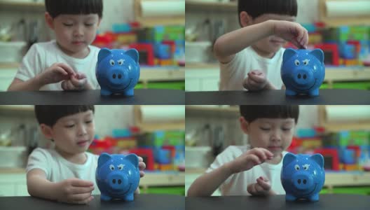 小男孩把一枚硬币放进扑满——孩子为未来存钱的概念高清在线视频素材下载