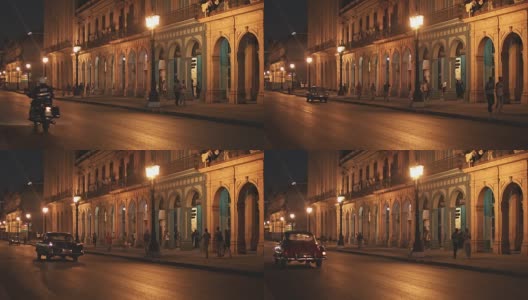 在城市建筑照亮的街道上的汽车高清在线视频素材下载